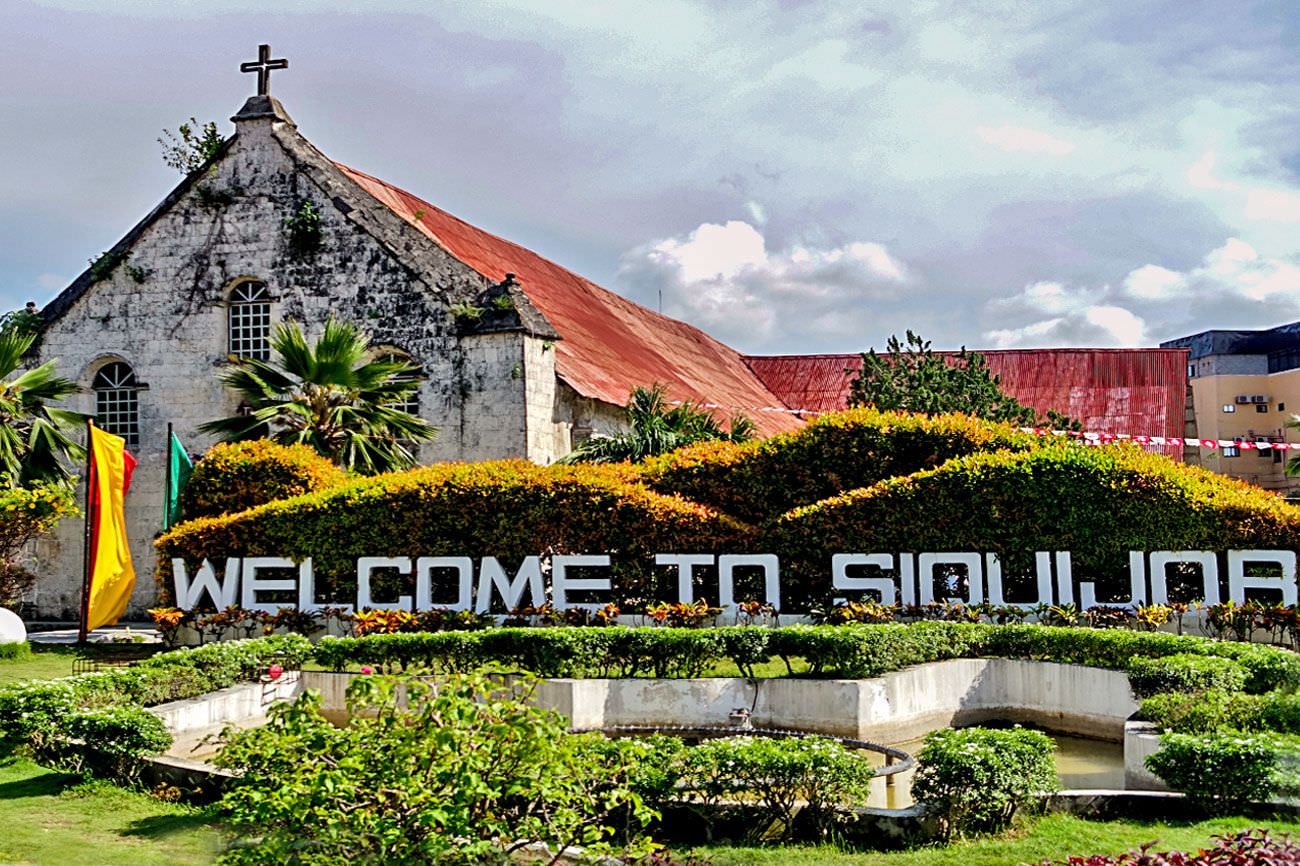 Siquijor Churche behind a Welcome to Siquijor Sign